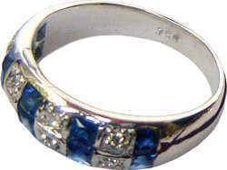 Ring with two linear rows consisting of alternating Ceylon blue sapphires and diamonds set in 18k white gold.