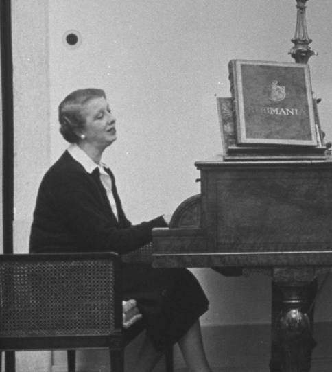 Elena Lupescu playing the piano in 1950. She seems to be wearing the same pair of pearl drop earrings 