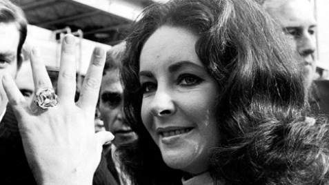 Elizabeth Taylor showing off the Krupp diamond ring, a piece of jewelry towards which she developed a strong personal attachment and became closely identified with her personality