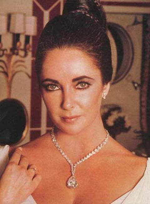 Elizabeth Taylor wearing a diamond necklace with the Taylor-Burton diamond as its pendant 