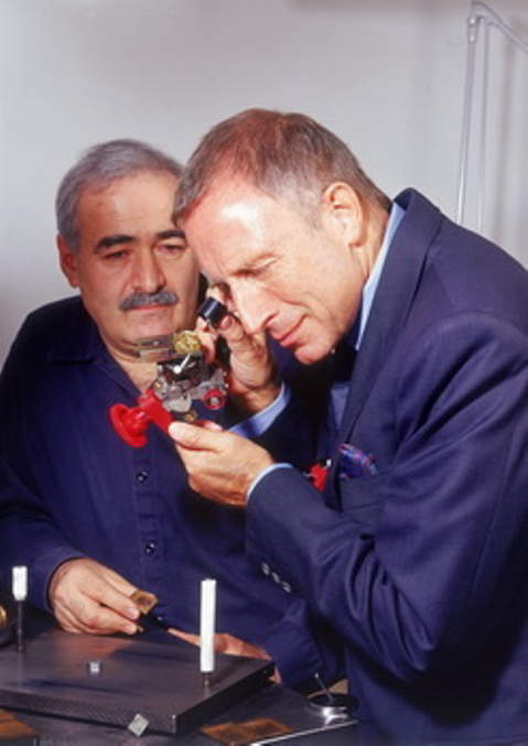 Laurence Graff inspecting the Golden Star Diamond while the late master cutter Nino Bianco looks on