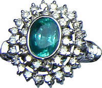 Cluster ring with a large Brazilian emerald and diamonds set in 18ct white gold.