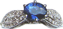 Ring of unique design with a large Ceylon(Sri Lanka) blue sapphire and diamonds set in 18 ct white gold.
