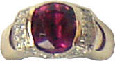 Ring with a large cushion cut rhodolite garnet in the center with diamonds on either side,set in 18k white gold.