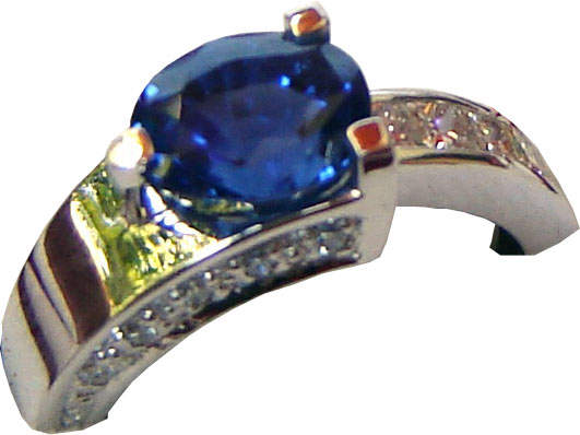 Ring of unique design with a Ceylon (Sri Lanka) blue sapphire and diamonds set in 18ct white gold.