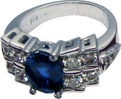 Attractive bridge ring with high quality large Ceylon blue sapphire and diamonds set in 18ct white gold.