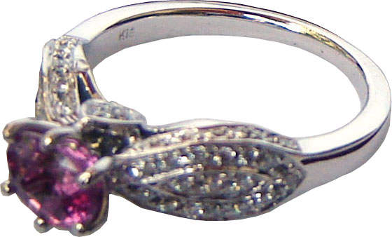 Ring of unique design with a large Ceylon(Sri Lanka) Pink Sapphire and diamonds set in 18 ct white gold.
