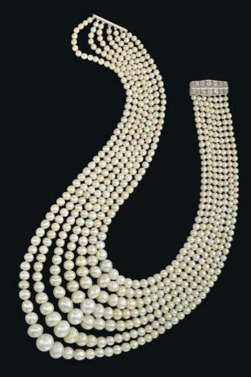 Seven-strand natural pearl and diamond necklace with the clasp open 