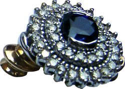 Cluster ring with a large Ceylon blue sapphire and two concentric rows of diamonds set in 18k gold.
